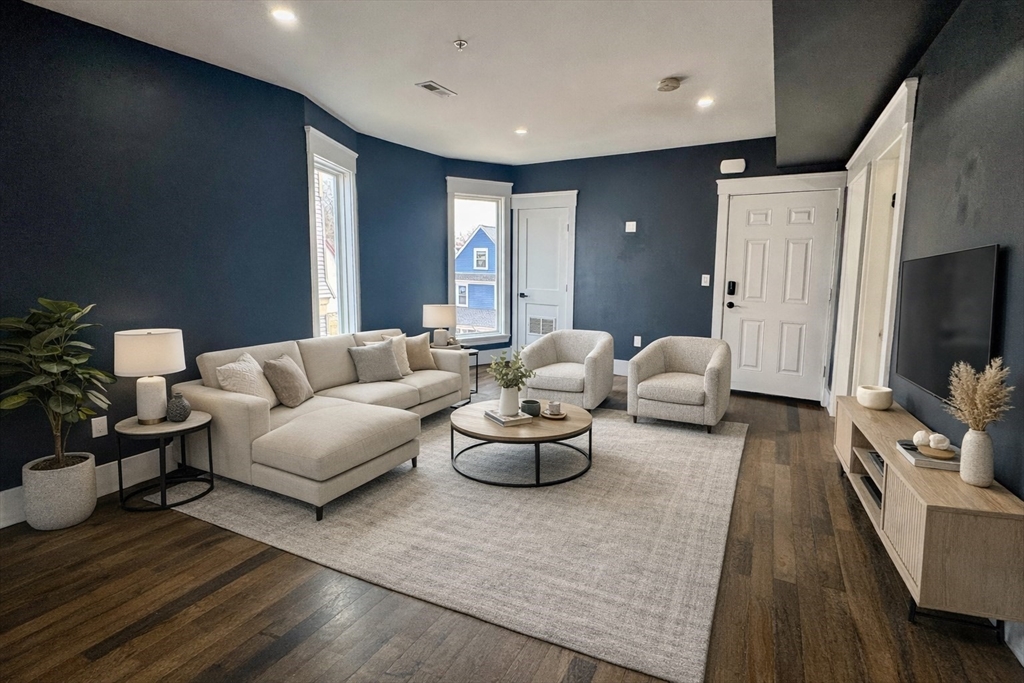 567 Park Street, Unit 3 Boston, MA 02124 - Photo 3 of 11 a living room with furniture and a flat screen tv