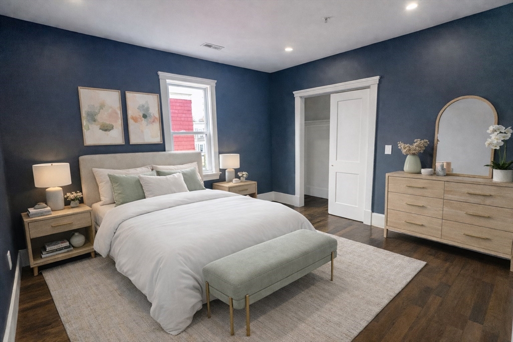 567 Park Street, Unit 3 Boston, MA 02124 - Photo 5 of 11 a bedroom with a bed and a dresser