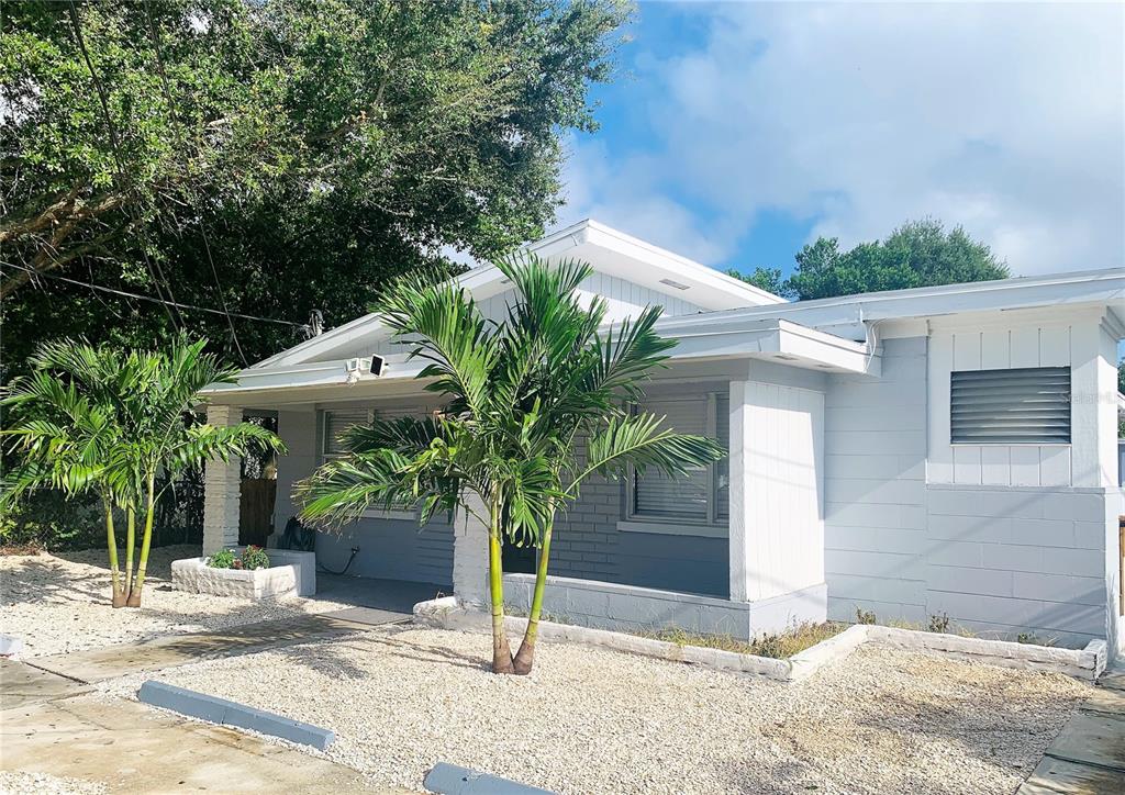 3805 West Leona Street, Unit 1 Tampa, FL 33629 - Photo 2 of 10 a wooden bench sitting in front of a house