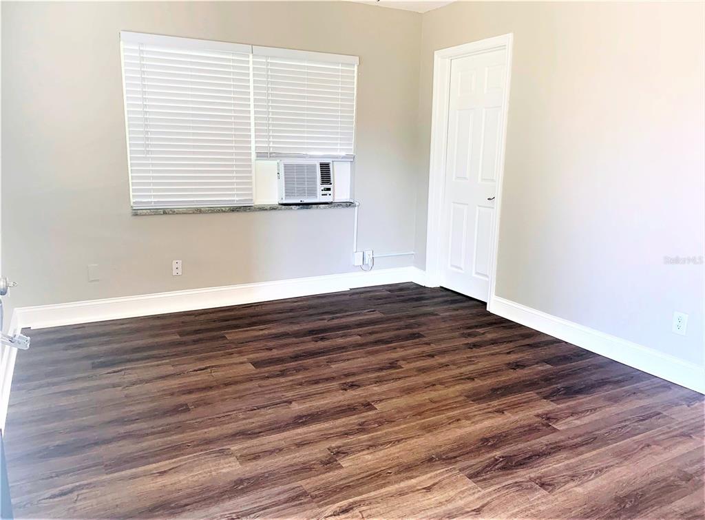 3805 West Leona Street, Unit 1 Tampa, FL 33629 - Photo 7 of 10 a view of an empty room with wooden floor and a window