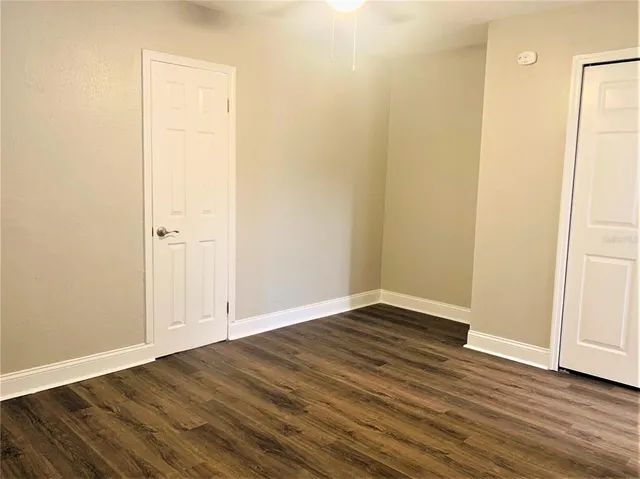 an empty room with wooden floor