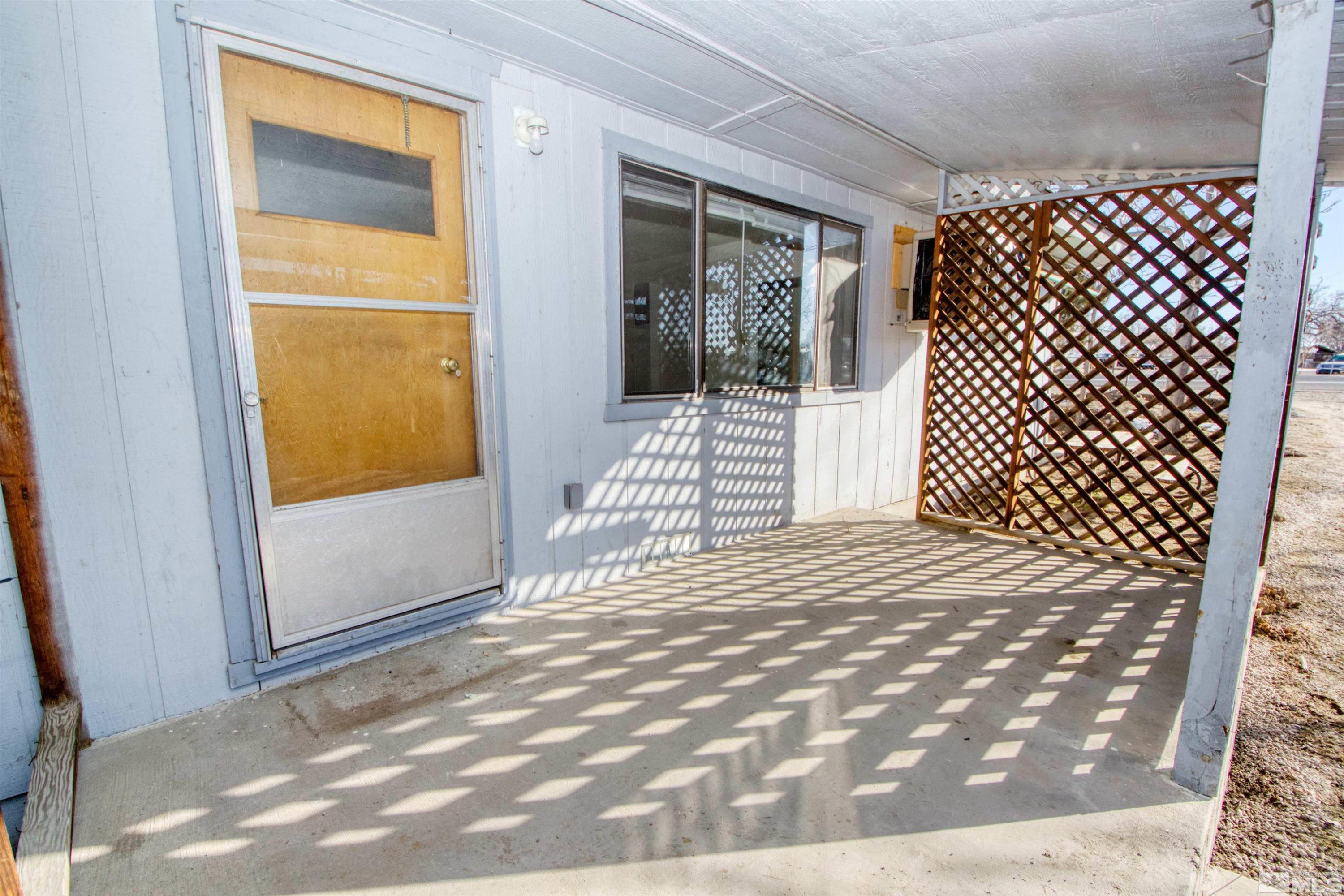 4300 Reno Highway, Unit 1 Fallon, NV 89406 - Photo 1 of 12 a bedroom with a bed and wooden floor