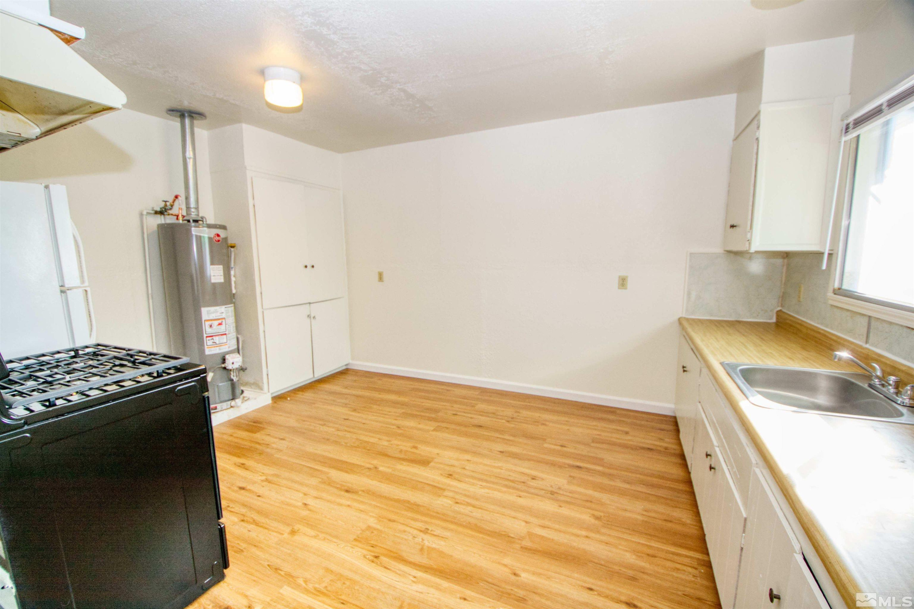 4300 Reno Highway, Unit 1 Fallon, NV 89406 - Photo 4 of 12 a kitchen with a stove and a refrigerator