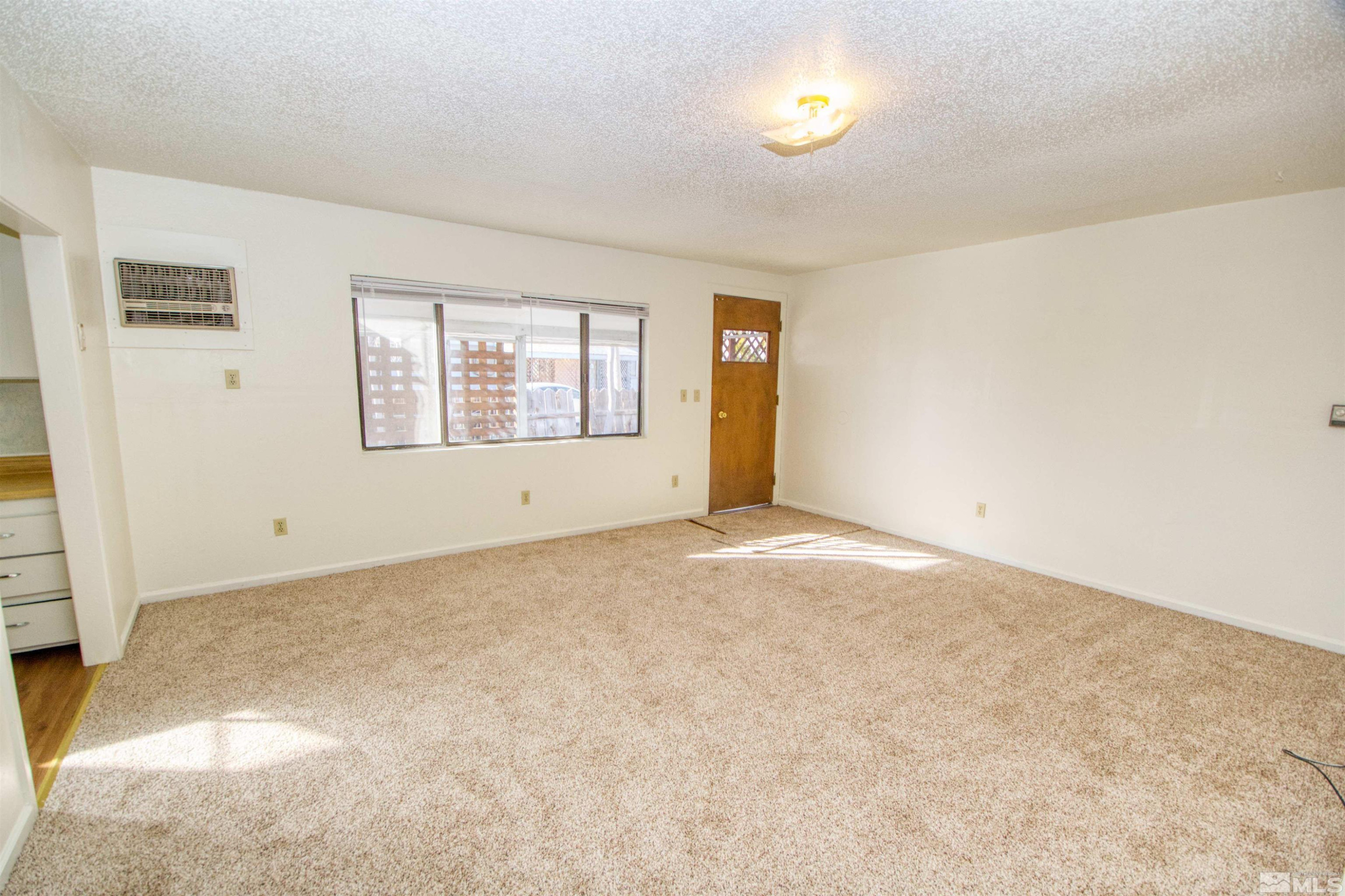 4300 Reno Highway, Unit 1 Fallon, NV 89406 - Photo 7 of 12 an empty room with windows