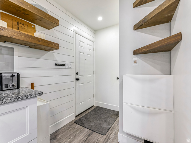 523 South Main Street Payson, UT 84651 - Photo 18 of 41 Entryway with wood-finish flooring, white shiplap accent wall, and a solid panel door
