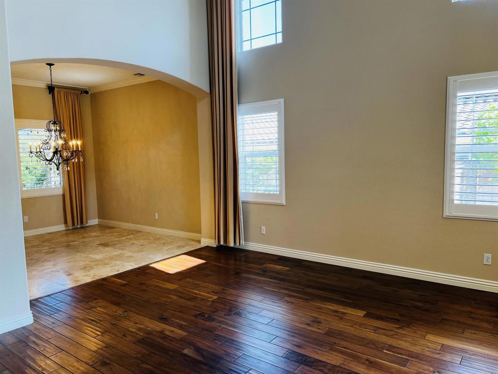 2834 Rancho Pancho Carlsbad, CA 92009 - Photo 12 of 73 a view of an empty room with wooden floor and a window