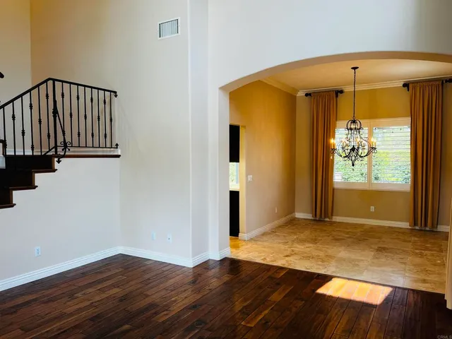 a kitchen with a sink and a stove top oven with wooden floor