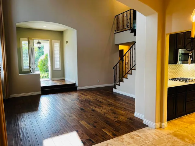 a view of kitchen with wooden floor and electronic appliances