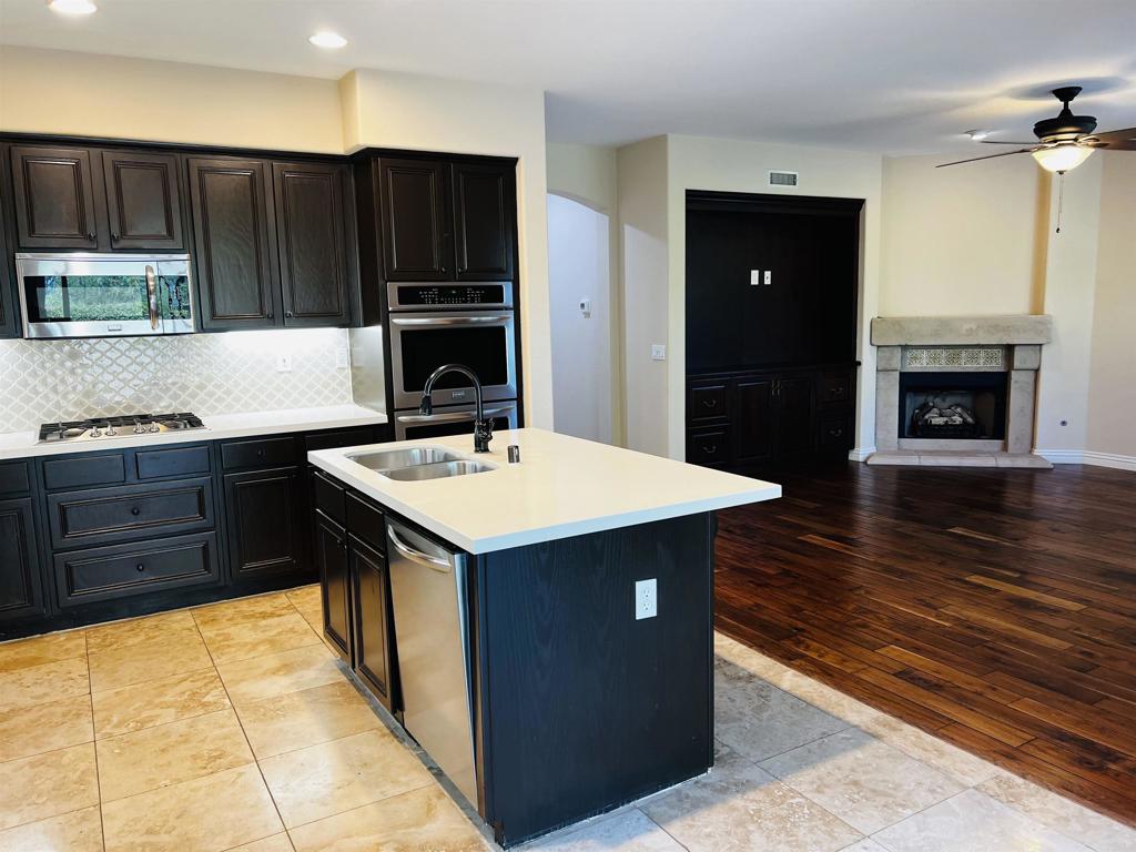 2834 Rancho Pancho Carlsbad, CA 92009 - Photo 20 of 73 a kitchen with wooden cabinets and a sink