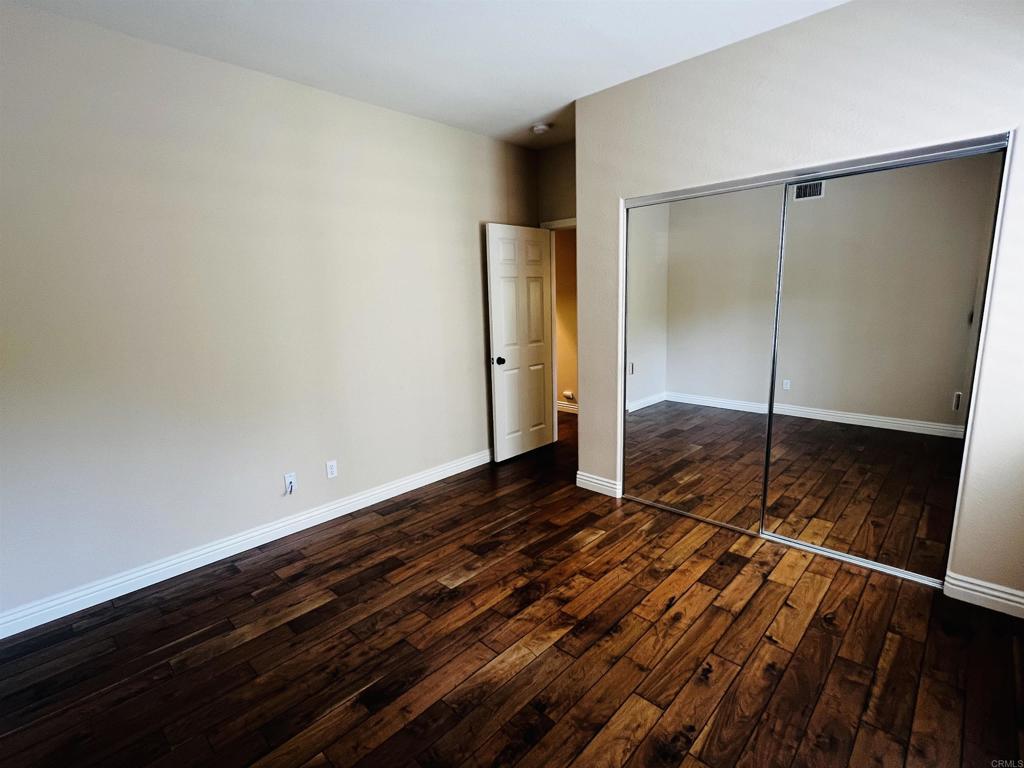 2834 Rancho Pancho Carlsbad, CA 92009 - Photo 28 of 73 a view of empty room with wooden floor and fan