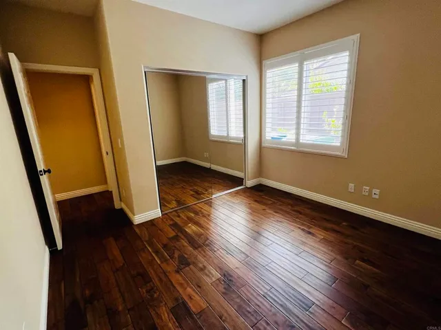 a balcony with wooden floor and outdoor space