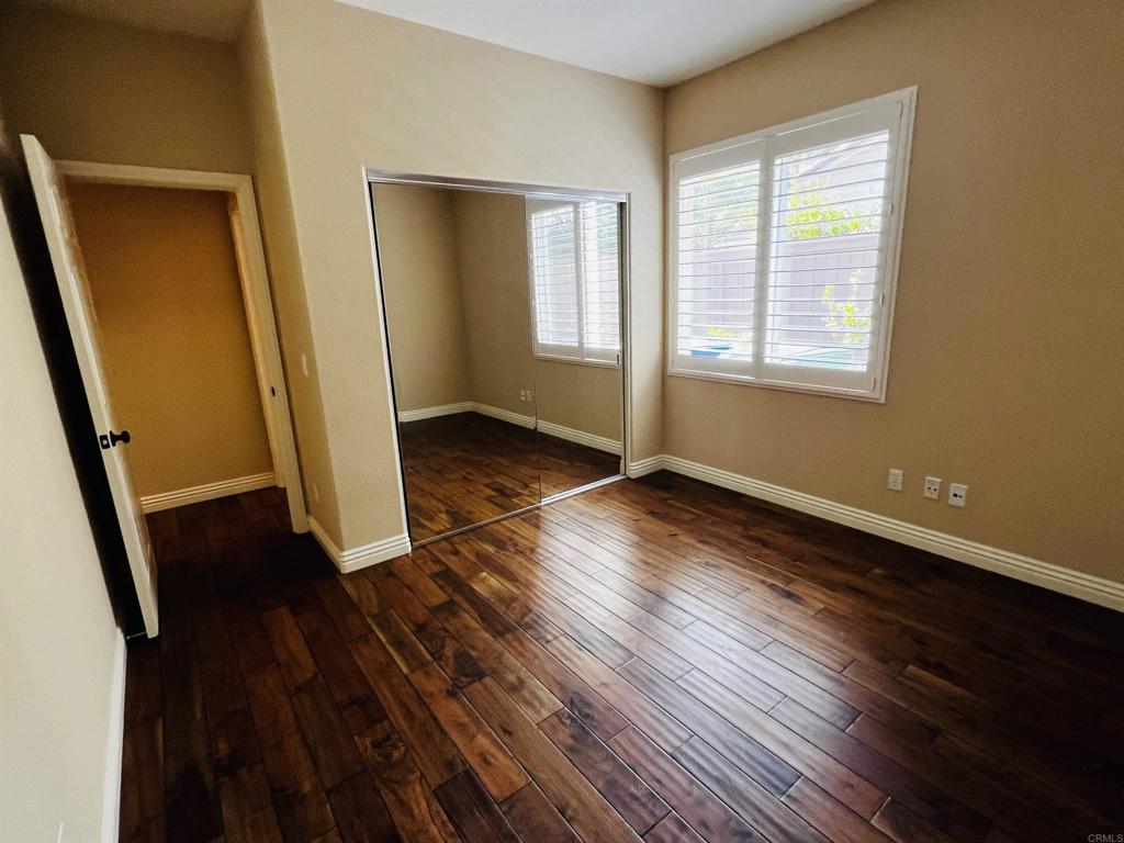 2834 Rancho Pancho Carlsbad, CA 92009 - Photo 29 of 73 a view of an empty room with wooden floor and a window