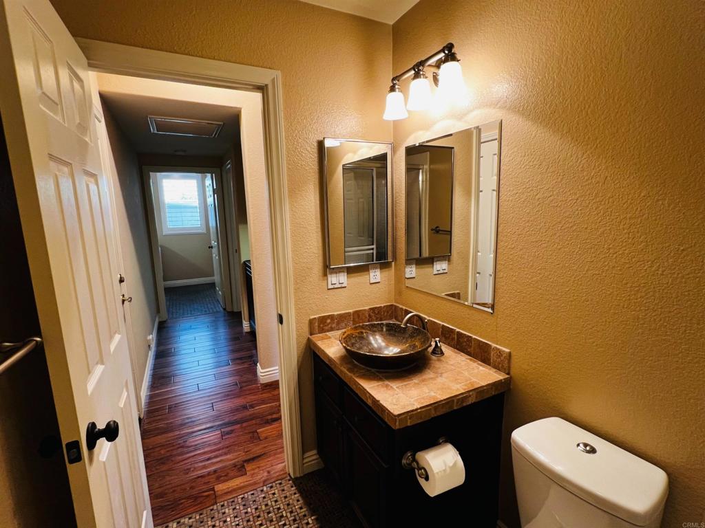 2834 Rancho Pancho Carlsbad, CA 92009 - Photo 31 of 73 a bathroom with a sink a toilet and mirror