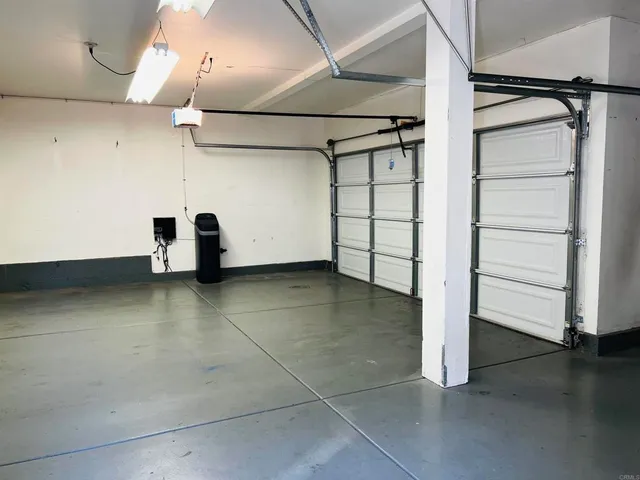 a view of a room with wooden floor and cabinets