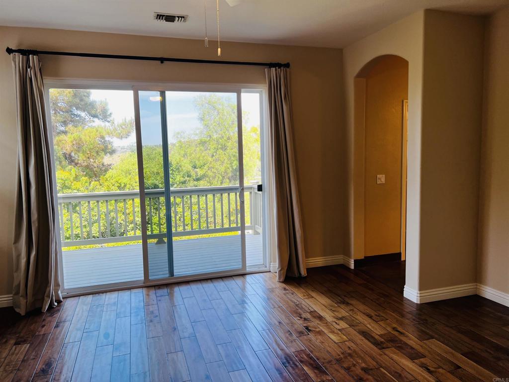 2834 Rancho Pancho Carlsbad, CA 92009 - Photo 36 of 73 a view of empty room with wooden floor and fan
