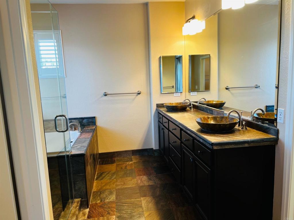 2834 Rancho Pancho Carlsbad, CA 92009 - Photo 43 of 73 a bathroom with a sink and a mirror