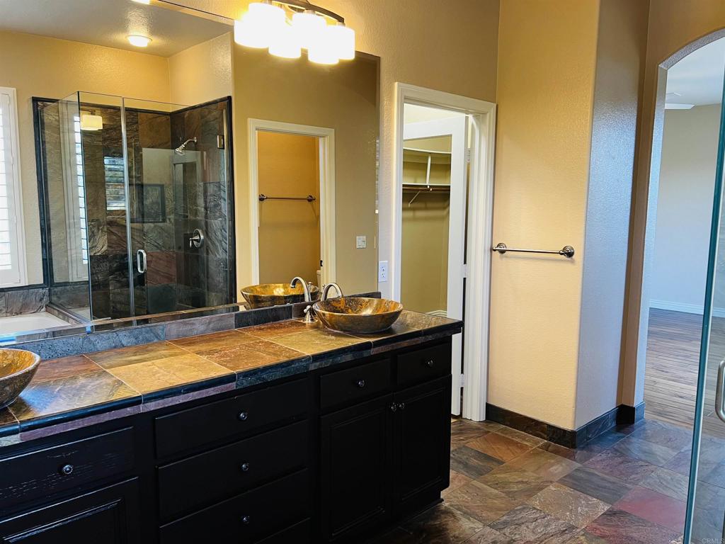 2834 Rancho Pancho Carlsbad, CA 92009 - Photo 45 of 73 a bathroom with a sink and a mirror