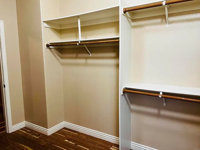a view of a swimming pool with a table and chairs under an umbrella