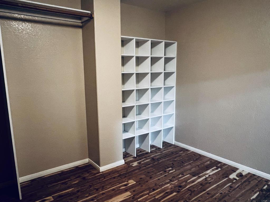2834 Rancho Pancho Carlsbad, CA 92009 - Photo 51 of 73 a view of a room with wooden floor and cabinets