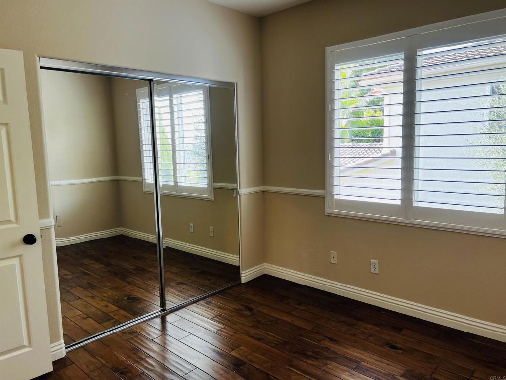 2834 Rancho Pancho Carlsbad, CA 92009 - Photo 52 of 73 a view of an empty room with wooden floor and a window