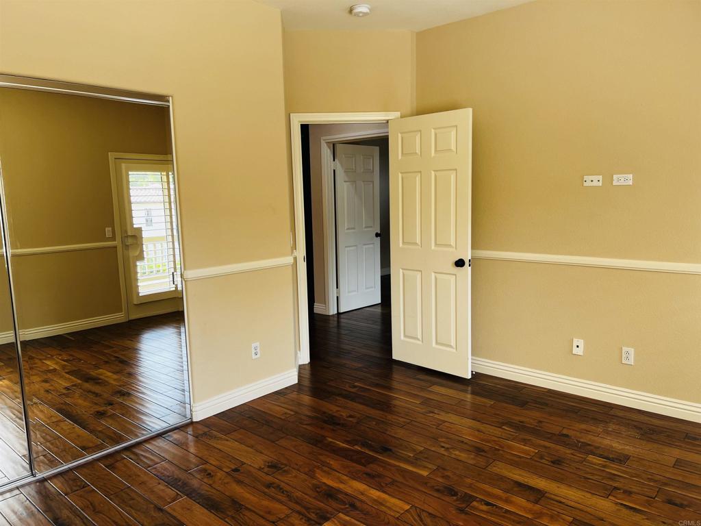 2834 Rancho Pancho Carlsbad, CA 92009 - Photo 56 of 73 an empty room with wooden floor and windows