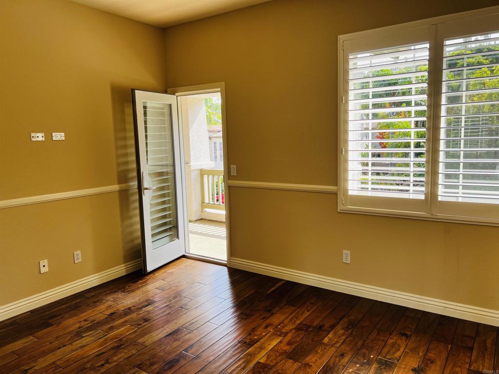 2834 Rancho Pancho Carlsbad, CA 92009 - Photo 57 of 73 a view of empty room with wooden floor and fan