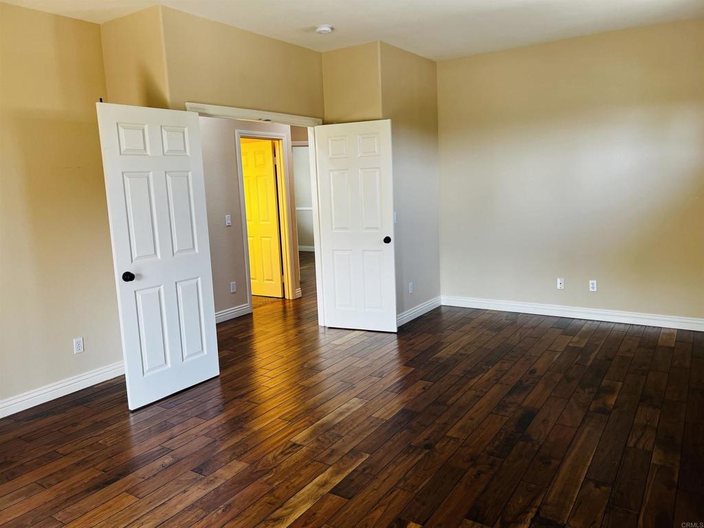 2834 Rancho Pancho Carlsbad, CA 92009 - Photo 61 of 73 a view of an empty room with wooden floor and a window