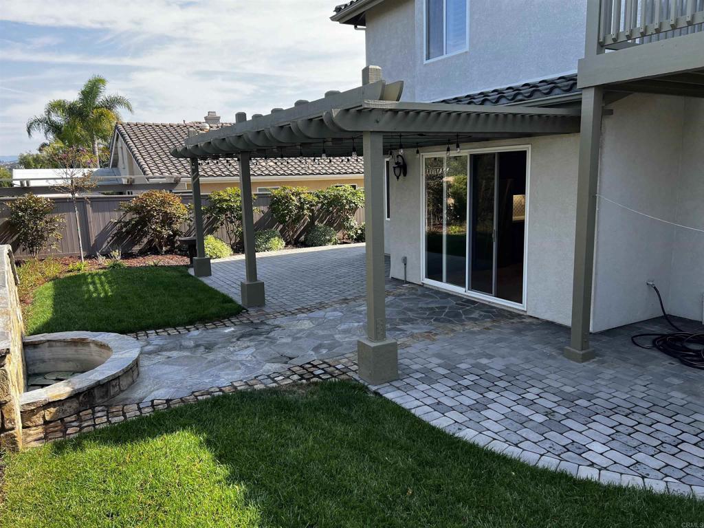 2834 Rancho Pancho Carlsbad, CA 92009 - Photo 9 of 73 a view of a chair and table in backyard of the house