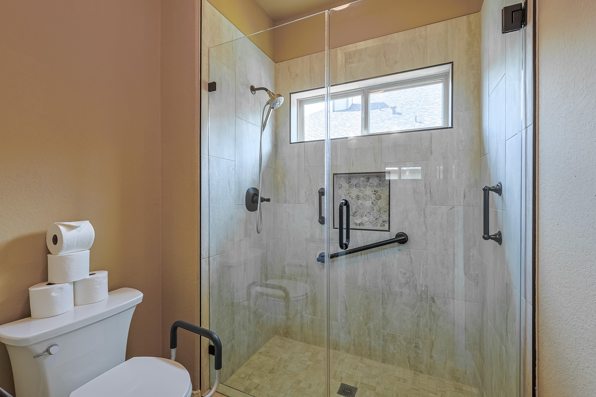 515 Mill Creek Road Pinehurst, TX 77362 - Photo 34 of 48 This bathroom features a spacious walk-in shower with a glass door, modern fixtures, and safety grab bars.