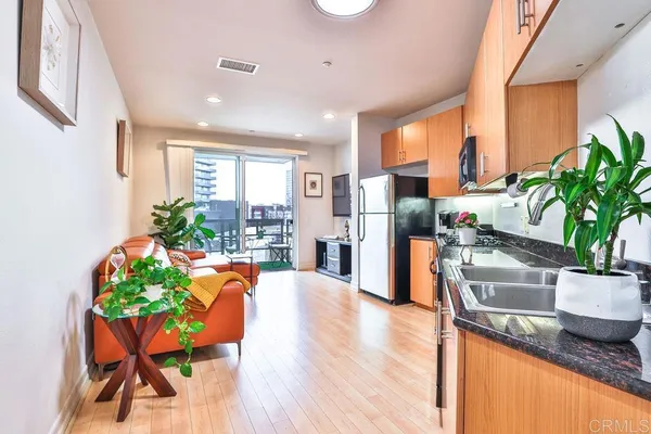 a kitchen with granite countertop a stove a sink and a microwave