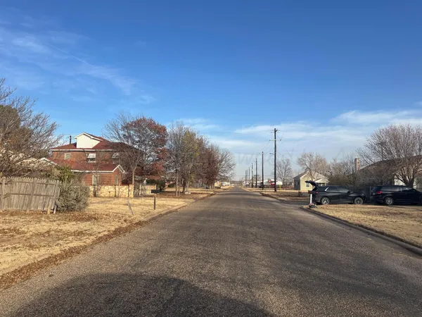 a view of a street with a building in the background