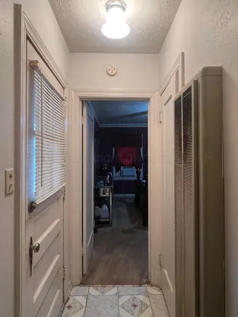 a view of a hallway and a livingroom with a furniture