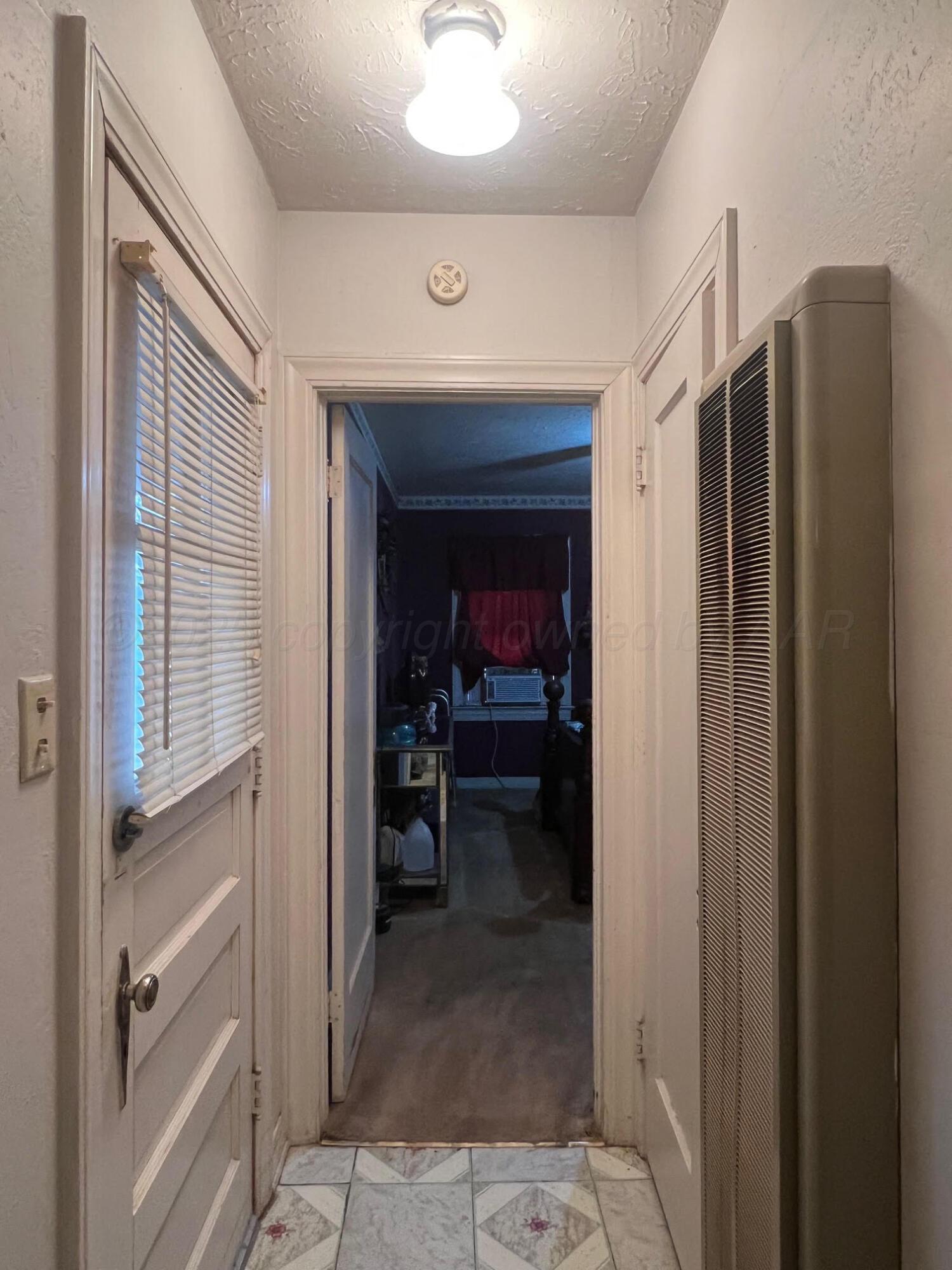 716 West Cleveland Street Memphis, TX 79245 - Photo 6 of 14 Back door and wall heater