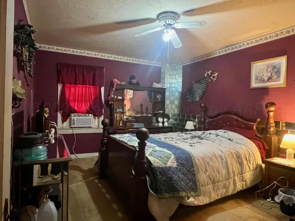 a bedroom with a bed and a mirror