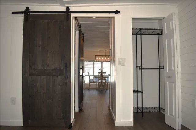 a view of empty room with wooden floor