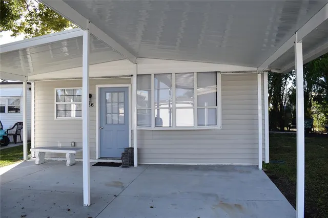 a view of a house with a backyard and a tree