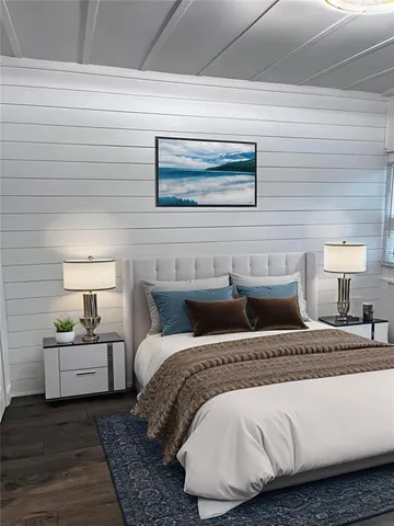 a view of a room with wooden floor and furniture