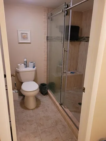 a bathroom with a toilet and a shower