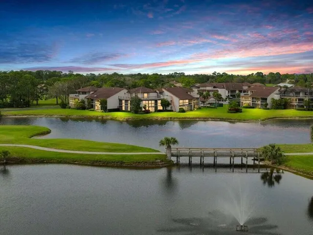a view of a lake with houses in the back