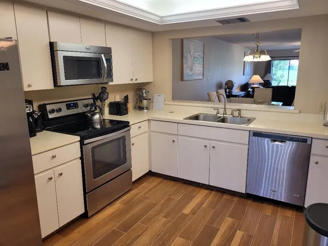 a kitchen with a sink stove and microwave