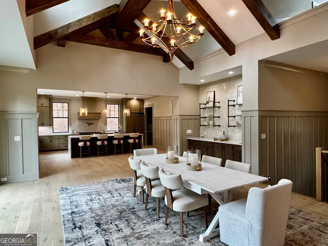 a living room with furniture a chandelier and a wooden floor