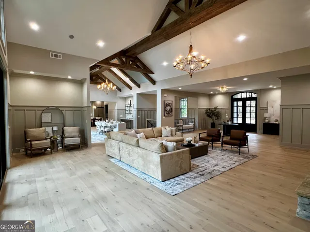 an aerial view of a house with a yard and lake view