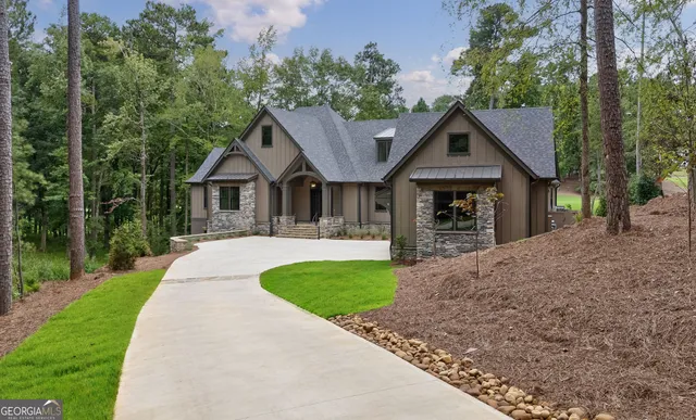 a front view of a house with a yard and trees