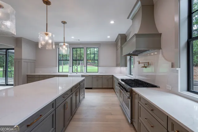 an empty room with windows fireplace and wooden floor