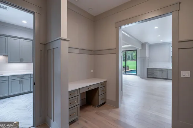 a bathroom with a large tub a sink a window and a glass door shower