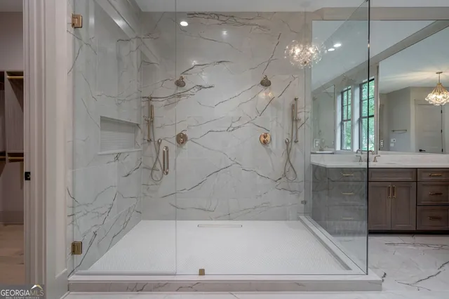 a bathroom with a double vanity sink toilet and shower