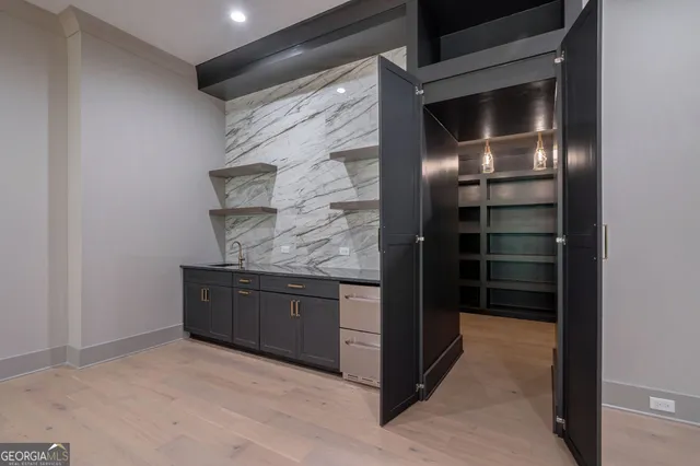 a bathroom with a granite countertop sink a toilet and shower