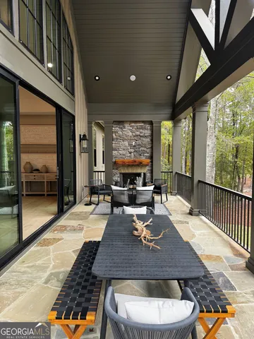 a dining room with wooden floor a chandelier a wooden table and chairs