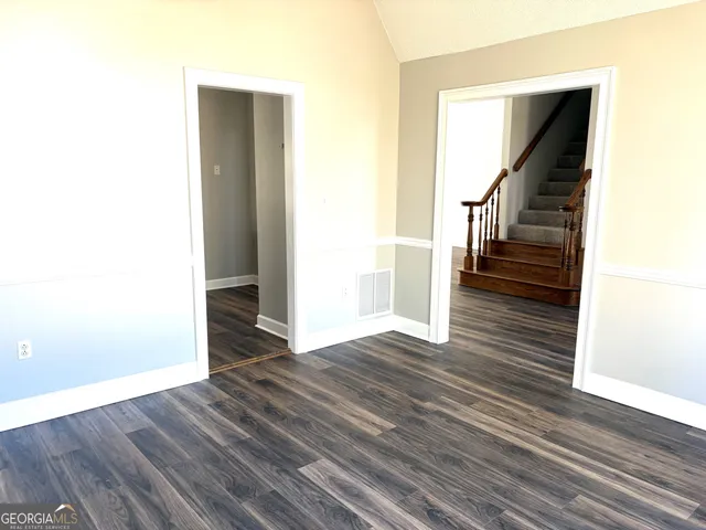 a view of entryway and hall with wooden floor