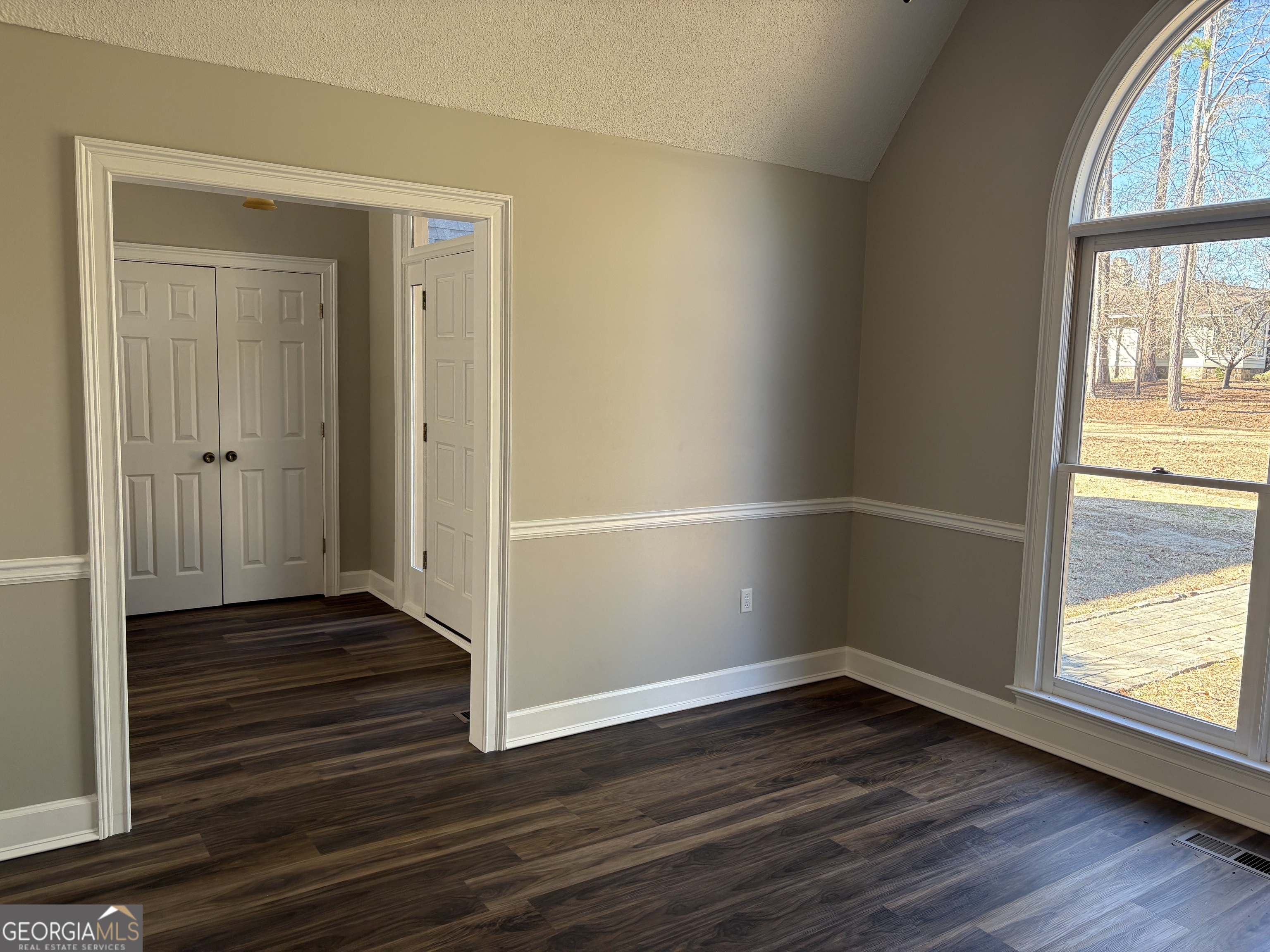 245 Woodland Street Dublin, GA 31021 - Photo 13 of 48 an empty room with wooden floor and windows